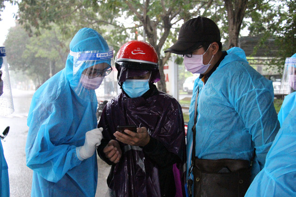 Tình nguyện viên hướng dẫn người dân đăng ký thông tin y tế. (Nguồn ảnh: tuoitre.vn)